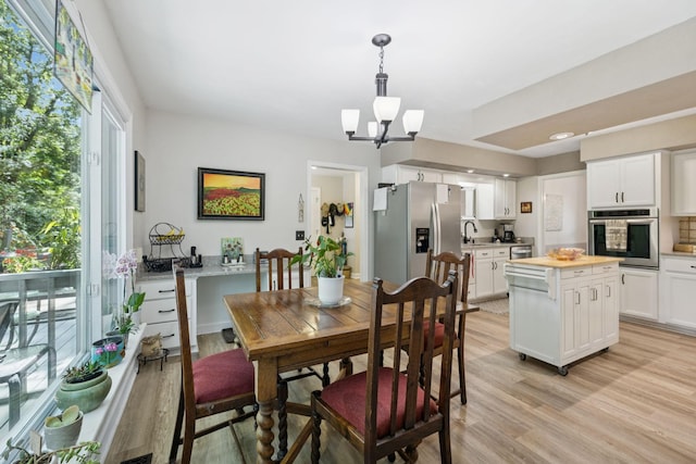 1201 Natchez Rd, Franklin, TN 37069 - dining area with light wood finished floors and a chandelier