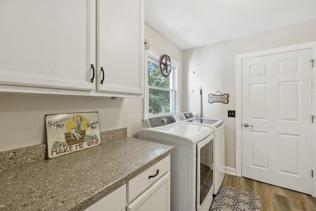 1201 Natchez Rd, Franklin, TN 37069 - laundry area featuring washer and clothes dryer, cabinet space, and light wood-type flooring