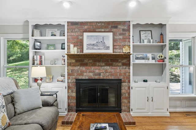 1201 Natchez Rd, Franklin, TN 37069 - living room featuring ornamental molding, a brick fireplace, light wood finished floors, and healthy amount of natural light
