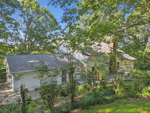 1201 Natchez Rd, Franklin, TN 37069 - view of home's exterior featuring roof with shingles, a patio, and a chimney