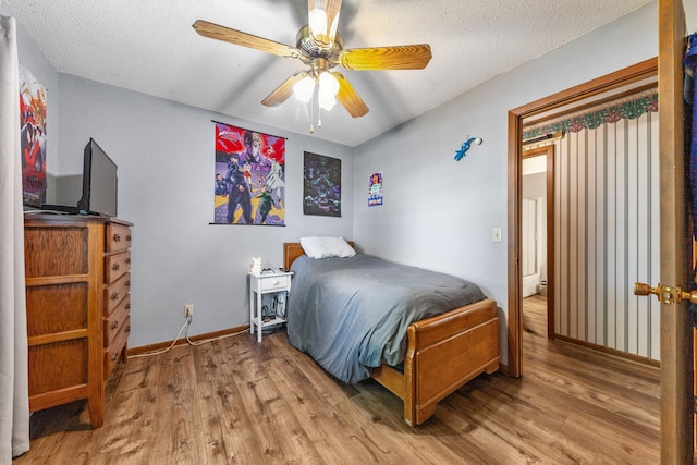 1150 Mattox Town Rd, Lawrenceburg, TN 38464 - bedroom featuring wood finished floors, a textured ceiling, and ceiling fan
