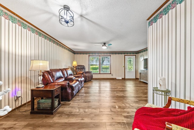 1150 Mattox Town Rd, Lawrenceburg, TN 38464 - living room with a textured ceiling, wood finished floors, ceiling fan, and wallpapered walls