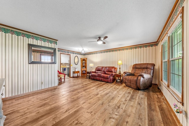 1150 Mattox Town Rd, Lawrenceburg, TN 38464 - living room featuring hardwood / wood-style floors, ceiling fan, a textured ceiling, and ornamental molding