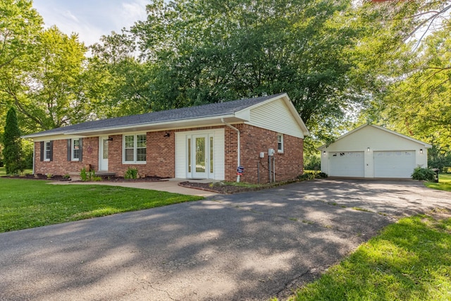 1150 Mattox Town Rd, Lawrenceburg, TN 38464 - ranch-style house featuring brick siding, an outdoor structure, a garage, a front lawn, and view of scattered trees