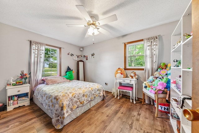 1150 Mattox Town Rd, Lawrenceburg, TN 38464 - bedroom featuring wood finished floors, a textured ceiling, and a ceiling fan
