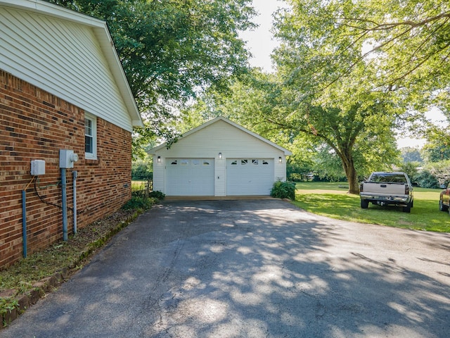 1150 Mattox Town Rd, Lawrenceburg, TN 38464 - view of side of home featuring an outbuilding, a detached garage, a yard, and brick siding