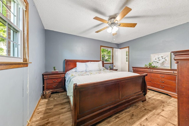 1150 Mattox Town Rd, Lawrenceburg, TN 38464 - bedroom featuring wood finished floors, a textured ceiling, and ceiling fan