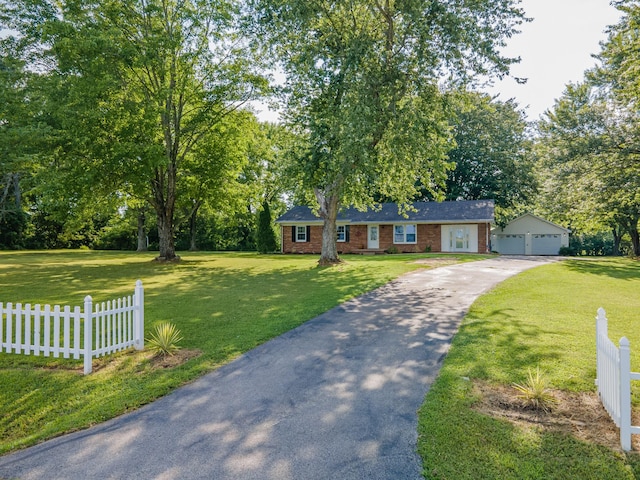 1150 Mattox Town Rd, Lawrenceburg, TN 38464 - view of front of property with a garage, an outdoor structure, brick siding, and view of wooded area