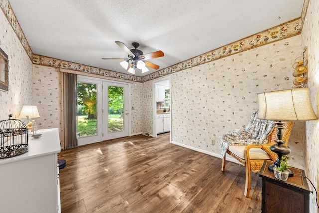 1150 Mattox Town Rd, Lawrenceburg, TN 38464 - living area featuring wallpapered walls, healthy amount of natural light, ceiling fan, and wood finished floors