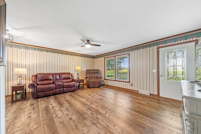 1150 Mattox Town Rd, Lawrenceburg, TN 38464 - living room featuring a ceiling fan, light wood-style floors, and ornamental molding