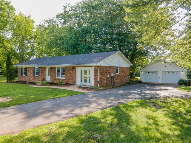 1150 Mattox Town Rd, Lawrenceburg, TN 38464 - ranch-style home with brick siding, a garage, french doors, an outbuilding, and a front lawn
