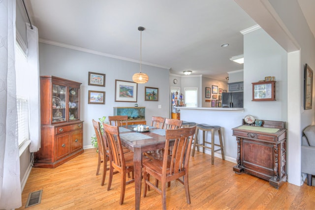 3307 Milton Ct, Thompsons Station, TN 37179 - dining area with ornamental molding and light wood-style flooring