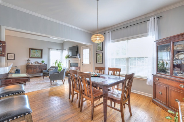3307 Milton Ct, Thompsons Station, TN 37179 - dining room with light wood-style floors, a fireplace, and crown molding