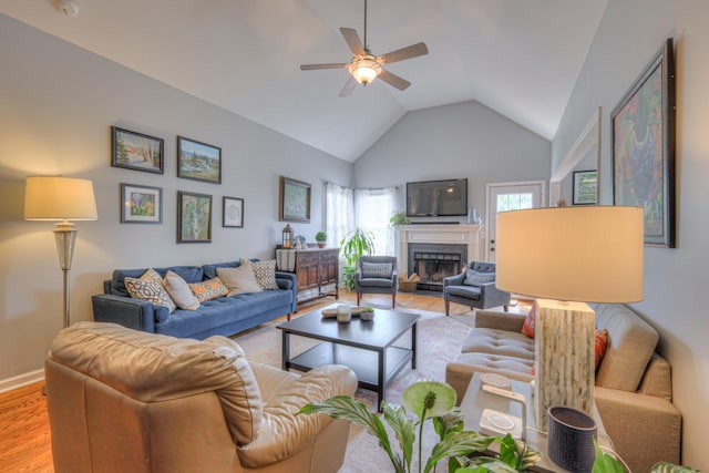 3307 Milton Ct, Thompsons Station, TN 37179 - living room featuring light wood-type flooring, ceiling fan, a glass covered fireplace, and high vaulted ceiling