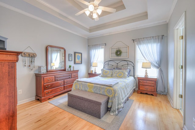 3307 Milton Ct, Thompsons Station, TN 37179 - bedroom with light wood-type flooring, a tray ceiling, crown molding, and ceiling fan