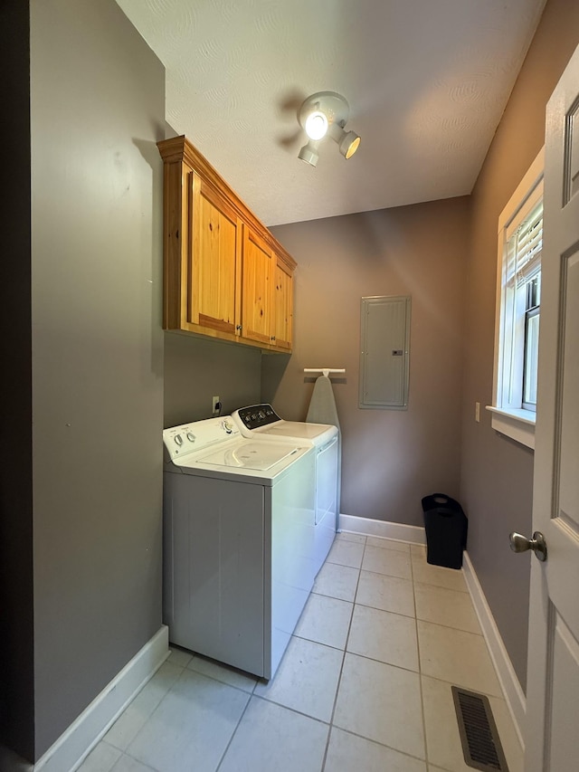 29 Bradley Ln, Bath Springs, TN 38311 - laundry room featuring electric panel, separate washer and dryer, cabinet space, and light tile patterned floors