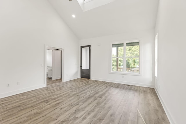 1111 W End Ave N, Lewisburg, TN 37091 - unfurnished living room with a skylight, high vaulted ceiling, light wood finished floors, and recessed lighting