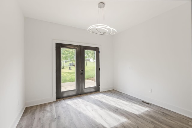 1111 W End Ave N, Lewisburg, TN 37091 - unfurnished room featuring french doors, a chandelier, and wood finished floors