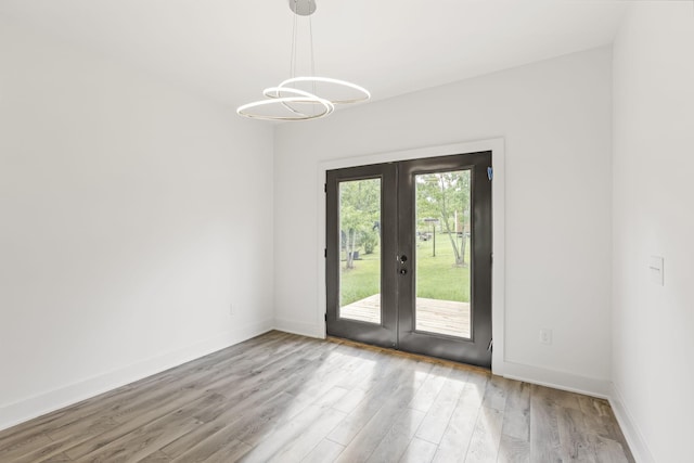 1111 W End Ave N, Lewisburg, TN 37091 - unfurnished room featuring french doors, light wood-style flooring, and a chandelier