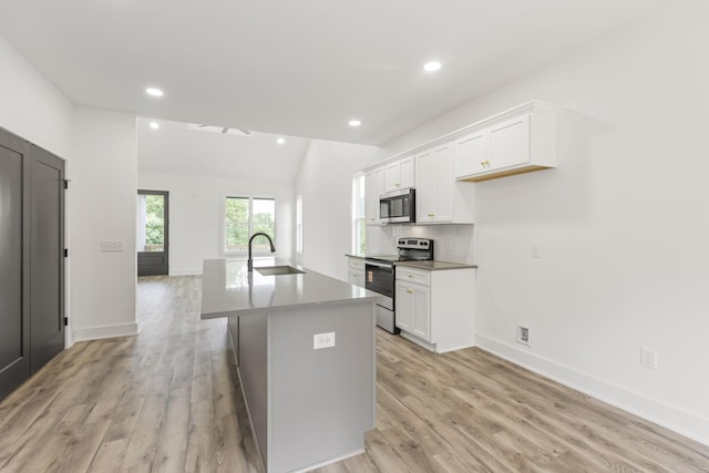 1111 W End Ave N, Lewisburg, TN 37091 - kitchen featuring appliances with stainless steel finishes, white cabinets, an island with sink, light wood-style flooring, and recessed lighting