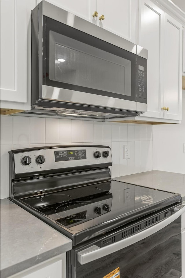 1111 W End Ave N, Lewisburg, TN 37091 - kitchen with appliances with stainless steel finishes, white cabinetry, and tasteful backsplash