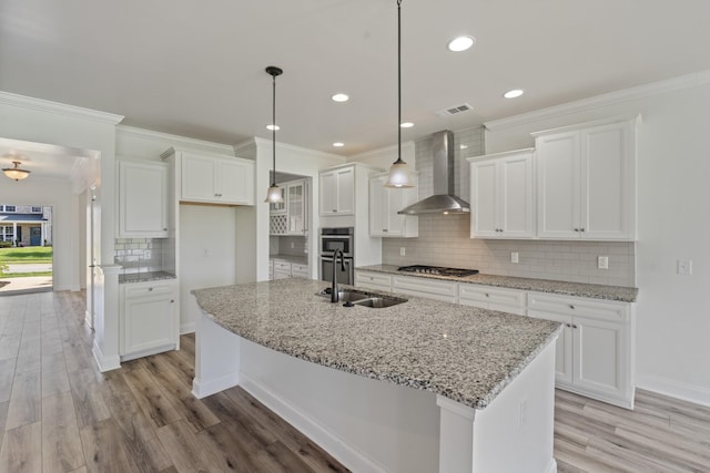2039 Friendship Dr, Spring Hill, TN 37174 - kitchen with wall chimney exhaust hood, appliances with stainless steel finishes, decorative backsplash, light wood-style floors, and recessed lighting