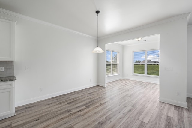 2039 Friendship Dr, Spring Hill, TN 37174 - unfurnished dining area featuring light wood-style floors and ornamental molding