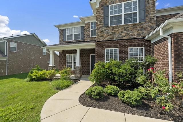 2039 Friendship Dr, Spring Hill, TN 37174 - property entrance featuring a yard, brick siding, and covered porch