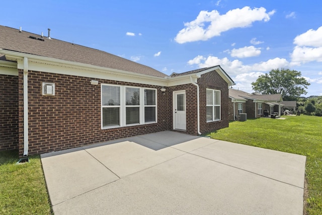 2039 Friendship Dr, Spring Hill, TN 37174 - rear view of house with brick siding, a patio area, and a lawn