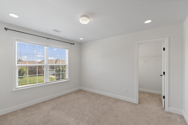 2039 Friendship Dr, Spring Hill, TN 37174 - unfurnished bedroom featuring light carpet, a spacious closet, recessed lighting, and a closet