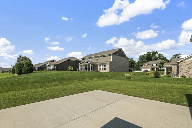2039 Friendship Dr, Spring Hill, TN 37174 - rear view of house featuring a yard, a patio area, a sunroom, and a residential view