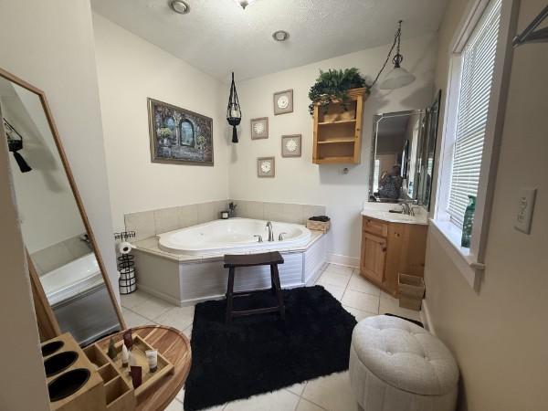 31 Bradley Ln, Bath Springs, TN 38311 - bathroom with vanity, tile patterned flooring, and a bath