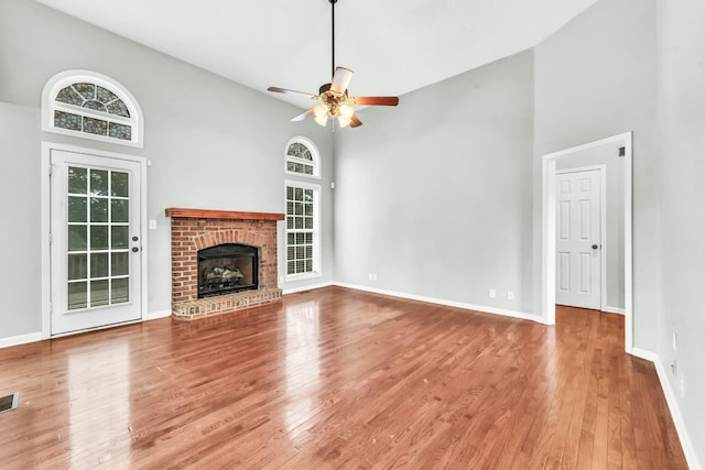 720 Superior Ln, Clarksville, TN 37043 - unfurnished living room featuring high vaulted ceiling, a ceiling fan, wood finished floors, and a brick fireplace