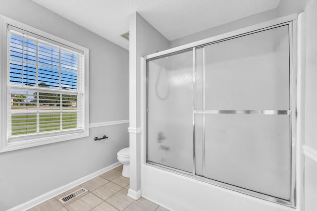720 Superior Ln, Clarksville, TN 37043 - bathroom with healthy amount of natural light, tile patterned floors, enclosed tub / shower combo, and a textured ceiling