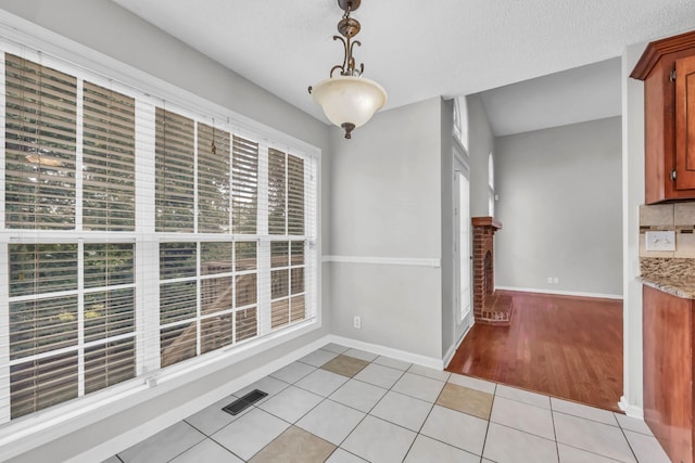 720 Superior Ln, Clarksville, TN 37043 - unfurnished dining area featuring light tile patterned flooring and a fireplace