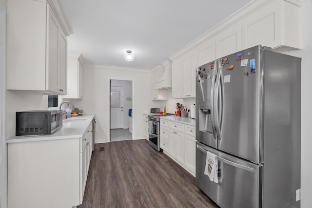 706 Running Deer Dr, Columbia, TN 38401 - kitchen featuring stainless steel appliances, dark wood-style floors, light countertops, white cabinets, and ornamental molding
