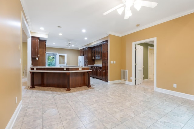 599 Countryside Dr, Loretto, TN 38469 - kitchen with a ceiling fan, ornamental molding, light countertops, freestanding refrigerator, and dark brown cabinetry