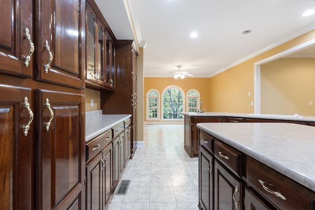 599 Countryside Dr, Loretto, TN 38469 - kitchen featuring ornamental molding, a ceiling fan, light countertops, dark brown cabinetry, and glass insert cabinets
