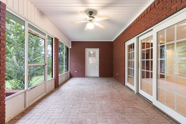 599 Countryside Dr, Loretto, TN 38469 - unfurnished sunroom featuring brick wall and brick flooring