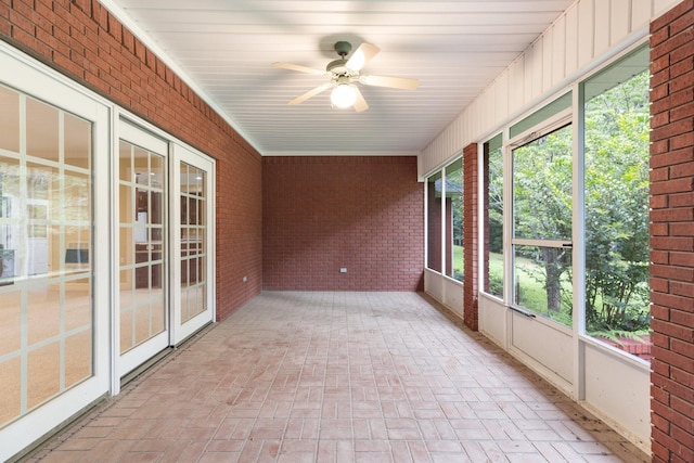 599 Countryside Dr, Loretto, TN 38469 - unfurnished sunroom featuring brick wall, brick flooring, ceiling fan, and plenty of natural light