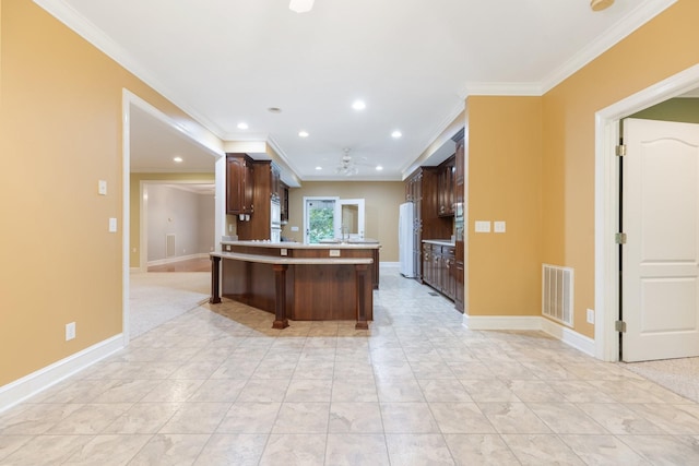 599 Countryside Dr, Loretto, TN 38469 - kitchen featuring ceiling fan, dark brown cabinets, recessed lighting, freestanding refrigerator, and a kitchen bar