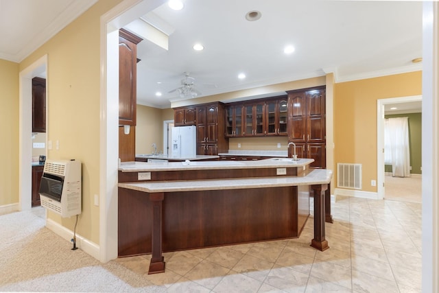 599 Countryside Dr, Loretto, TN 38469 - kitchen featuring heating unit, white fridge with ice dispenser, ornamental molding, ceiling fan, and a kitchen bar