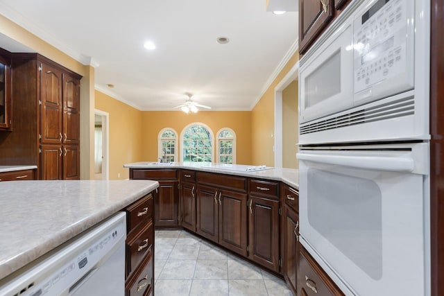 599 Countryside Dr, Loretto, TN 38469 - kitchen featuring white appliances, crown molding, light countertops, ceiling fan, and a peninsula