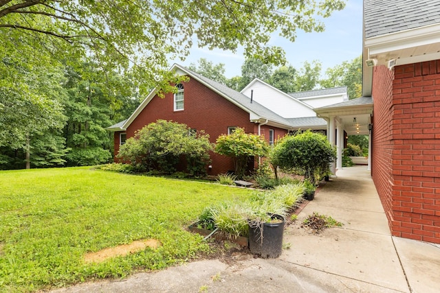 599 Countryside Dr, Loretto, TN 38469 - view of home's exterior featuring brick siding and a yard
