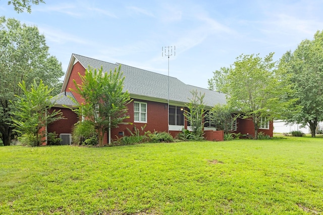 599 Countryside Dr, Loretto, TN 38469 - view of front of house featuring a front lawn, roof with shingles, and brick siding