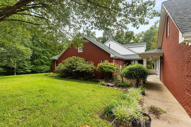599 Countryside Dr, Loretto, TN 38469 - view of home's exterior featuring a yard, brick siding, and roof with shingles