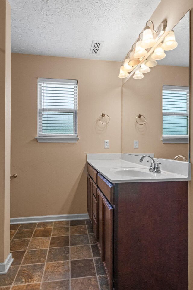 4114 Giacomo Dr, Murfreesboro, TN 37128 - bathroom featuring vanity, healthy amount of natural light, a textured ceiling, and stone finish flooring