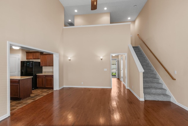 4114 Giacomo Dr, Murfreesboro, TN 37128 - unfurnished living room with a towering ceiling, dark wood-style flooring, stairway, recessed lighting, and a ceiling fan