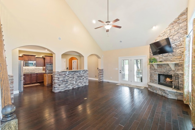 5010 Moretto Ct, Spring Hill, TN 37174 - unfurnished living room with a ceiling fan, high vaulted ceiling, a stone fireplace, and dark wood-type flooring