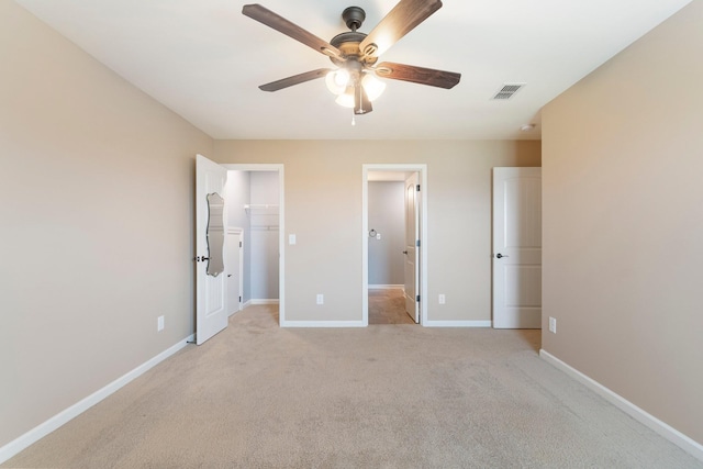 5010 Moretto Ct, Spring Hill, TN 37174 - unfurnished bedroom featuring light carpet, a spacious closet, ensuite bathroom, ceiling fan, and a closet